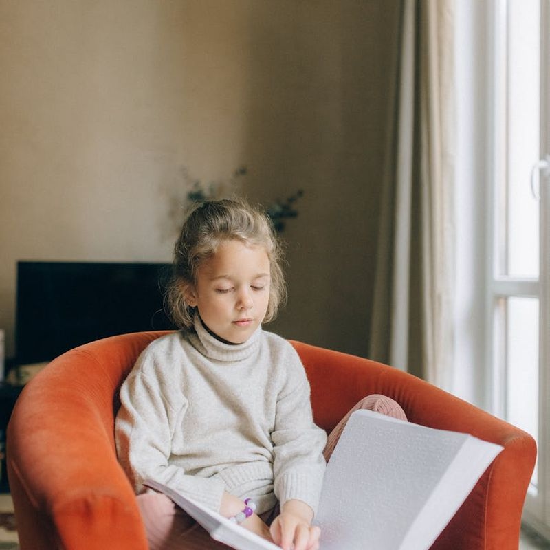 A child sitting quietly with eyes closed, showing concentration.